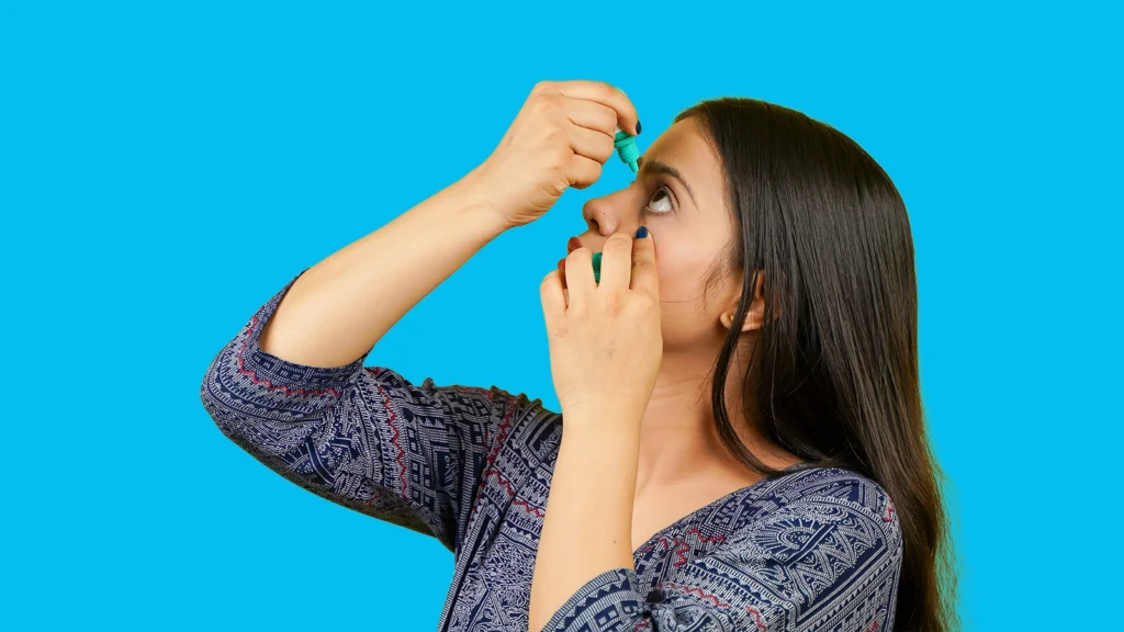 woman using eye drops