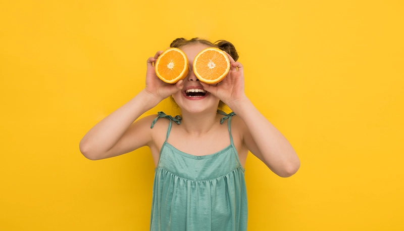 Girl holding oranges